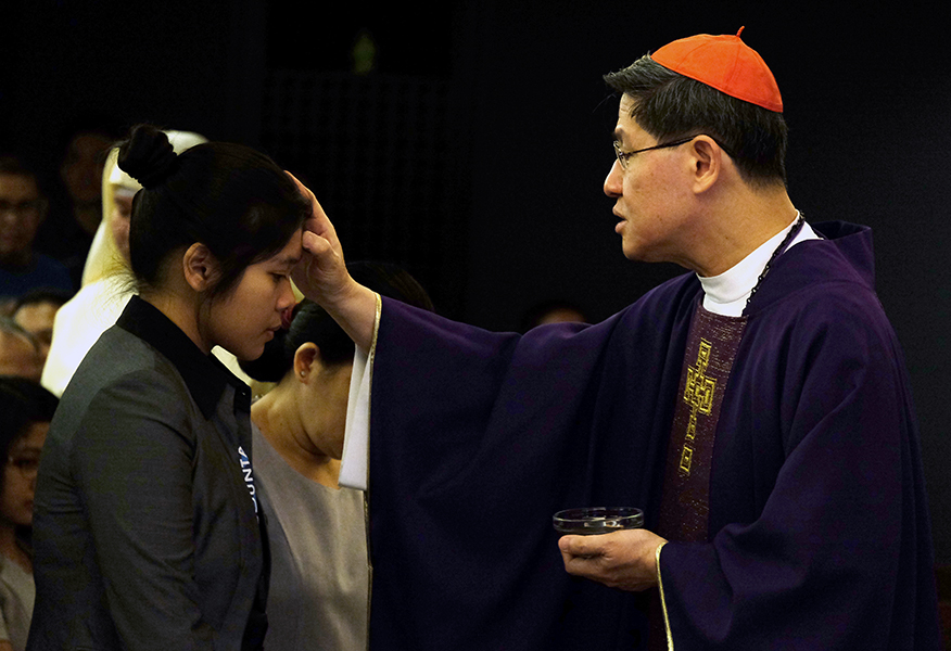 Cardinal Luis Antonio Tagle places ashes on the head of a woman during the Ash Wednesday Mass at the Manila archdiocese chapel in Intramuros, Manila, March 1, 2017. ROY LAGARDE 