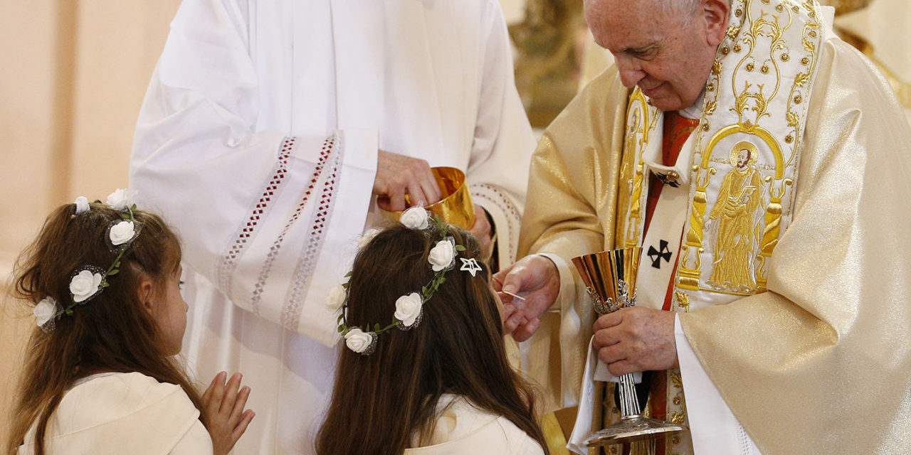 After offering instruction, pope gives first Communion to 245 children